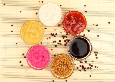 Various sauces on bamboo mat clipart