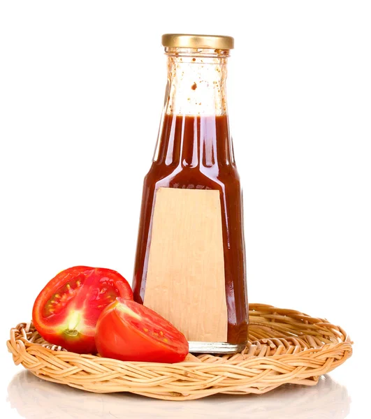 Tomato sauce in bottle on wicker mat isolated on white — Stock Photo, Image