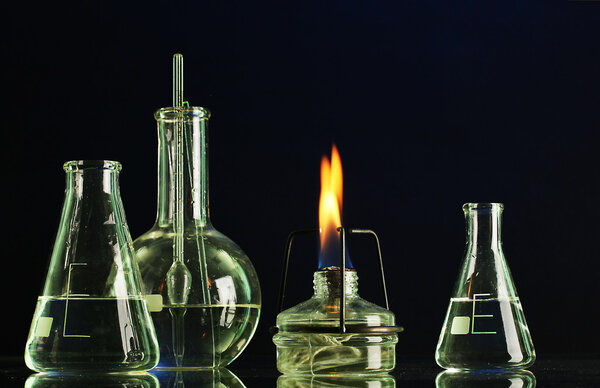 Spiritlamp and test-tubes on blue background