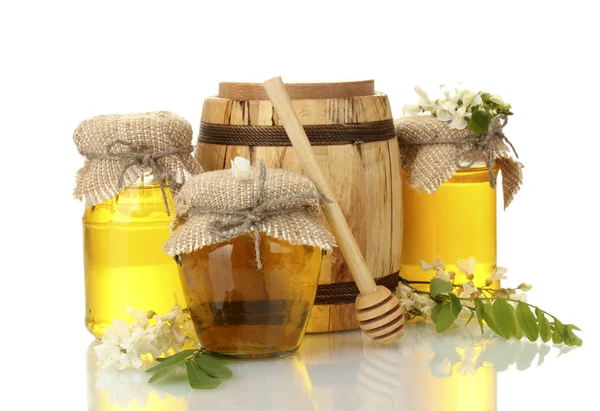 Sweet honey in barrel and jars with acacia flowers isolated on white — Stock Photo, Image