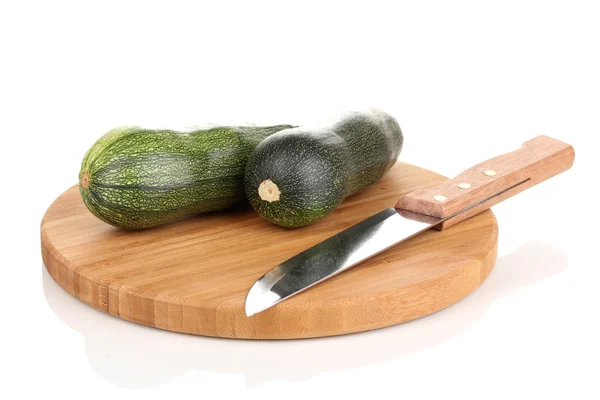 Fresh zucchini on chopping board isolated on white — Stock Photo, Image