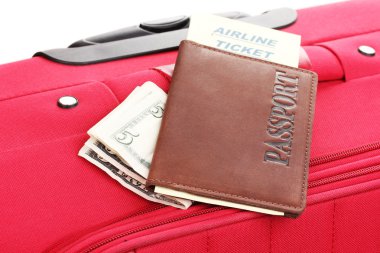 Passport and ticket on suitecase close-up clipart