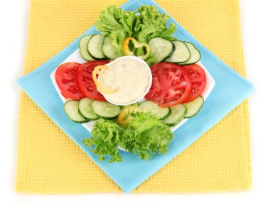 Chopped vegetables and sauce on plate isolated on white