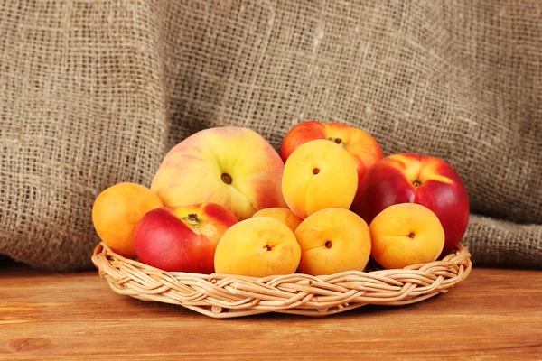 Ripe fruit on wicker mat on canvas background close-up — Stock Photo, Image
