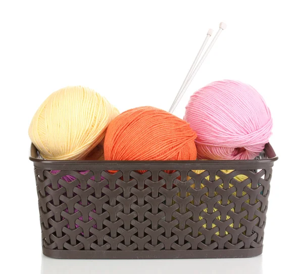 Women's hobby. Crochet and knitting. Yarns in basket on pink palka dot  background, crocheting supplies. Stock Photo