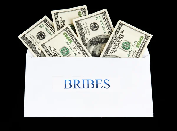 stock image The envelope with the money bills isolated on black. Bribes.