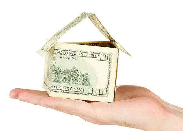 Hand holding een huis gemaakt van dollars op witte achtergrond close-up — Stockfoto