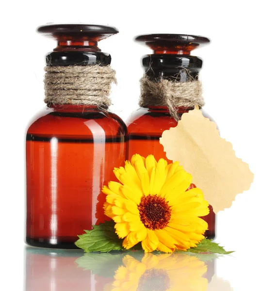 Medicine bottles and beautiful calendula flowers, isolated on white — Stock Photo, Image