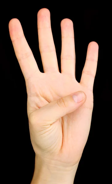 Ręka, co znak na czarnym tle — Zdjęcie stockowe