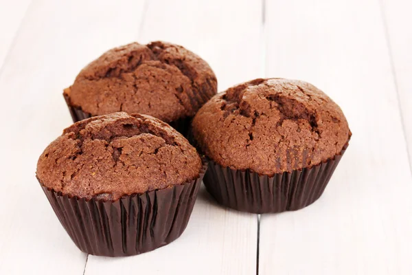Fresh muffins on wooden background — Stock Photo, Image