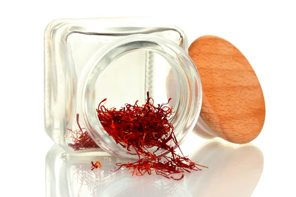 Stigmas of the saffron poured out a glass jar isolated on white — Stock Photo, Image