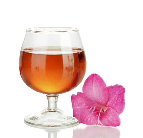 Glass with cocktail and gladiolus bud isolated on white — Stock Photo, Image