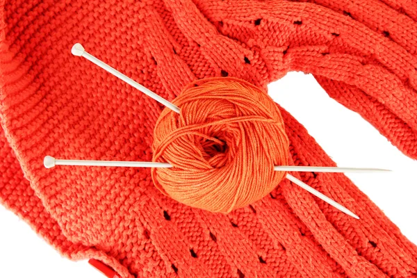 Оранжевый свитер и шарик шерсти крупным планом — стоковое фото