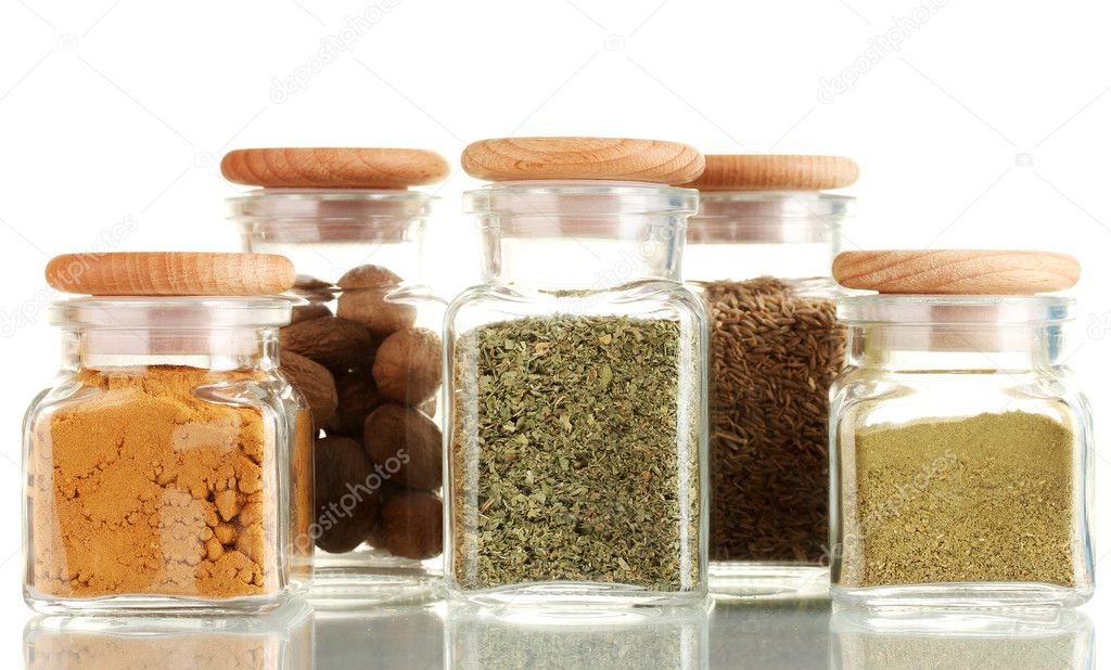 Powder spices in glass jars isolated on white