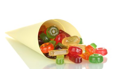 Tasty colorful candies in bright bag isolated on white clipart