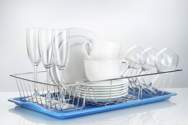 Clean dishes on stand isolated on white clipart