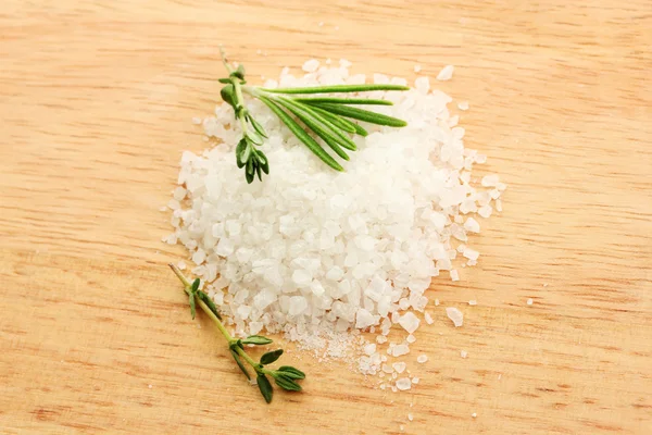 Соль со свежим розмарином и тимьяном на деревянном фоне — стоковое фото