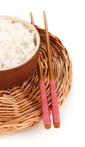 Bowl of rice and chopsticks on wicker mat isoalted on white — Stock Photo, Image