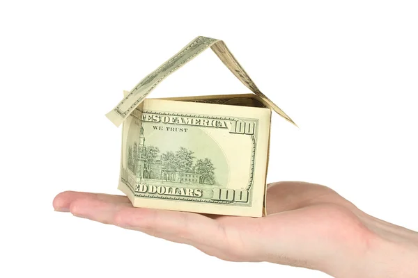 सफेद पृष्ठभूमि बंद-अप पर डॉलर से बने एक घर को हाथ पकड़ते हुए — स्टॉक फ़ोटो, इमेज
