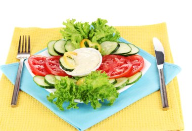 Chopped vegetables and sauce on plate isolated on white