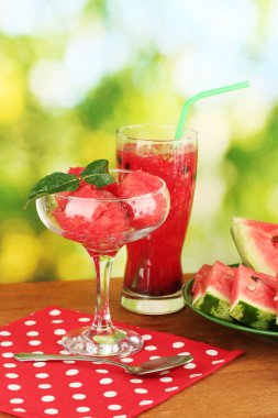 Refreshing desserts of watermelon on green background close-up clipart