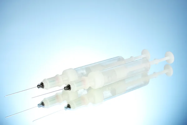 Syringes monovet on blue background — Stock Photo, Image