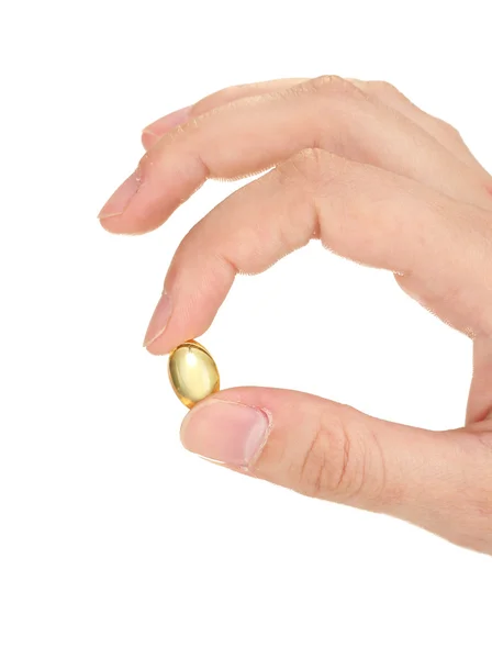 Woman's hand holds a pellets of fish oil on white background close-up — Stock Photo, Image