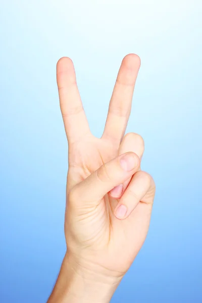 Hand making sign on blue background — Stock Photo, Image