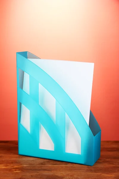 Blue tray for papers on red background close-up — Stock Photo, Image