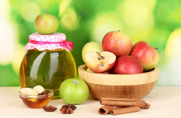 stock image Honey and apples with cinnamon on wooden table on natural background