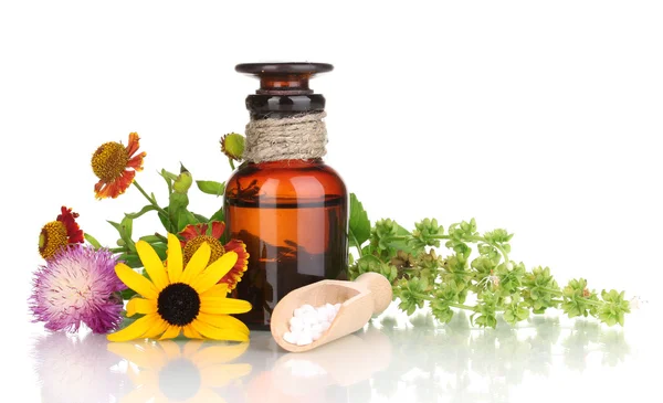 Medicine bottle with tablets and flowers isolated on white — Stock Photo, Image