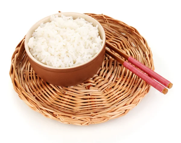 Bowl of rice and chopsticks on wicker mat isoalted on white — Stock Photo, Image