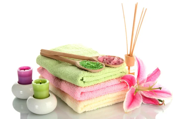 Towels with lily, aroma oil, candles and sea salt isolated on white — Stock Photo, Image
