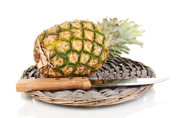Pineapple on wicker mat isolated on white — Stock Photo, Image