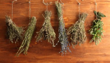 Dried herbs, on wooden background clipart