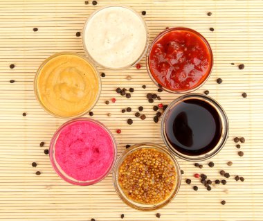 Various sauces on bamboo mat clipart