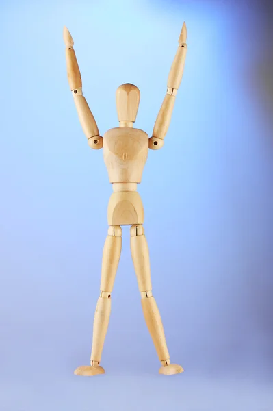 Wooden mannequin, on blue background — Stock Photo, Image