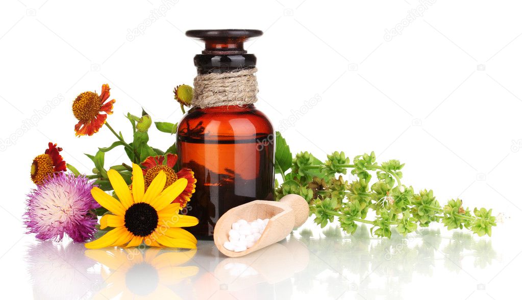 Medicine bottle with tablets and flowers isolated on white