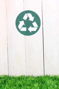 Recycling sign on wooden background clipart