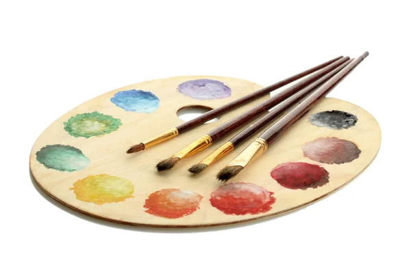 Wooden art palette with paint and brushes isolated on white — Stock Photo, Image