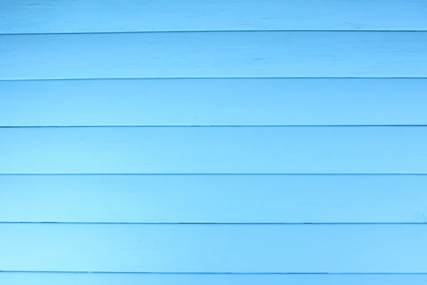Niebieskim tle drewniane — Zdjęcie stockowe