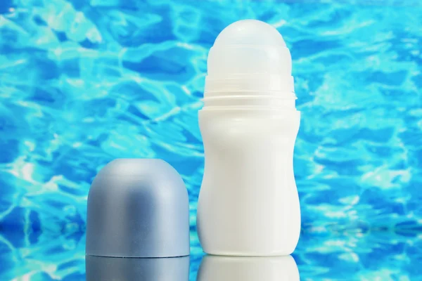 Deodorant na pozadí modré moře — Stock fotografie
