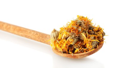 Dried calendula flowers in wooden spoon, isolated on white clipart