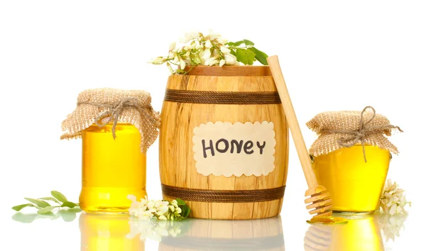 Sweet honey in barrel and jars with acacia flowers isolated on white — Stock Photo, Image