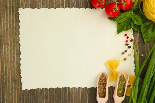 stock image Paper for recipes vegetables, and spices on wooden table