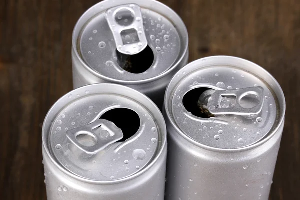 Aluminum cans with water drops on brown background — Stock Photo, Image