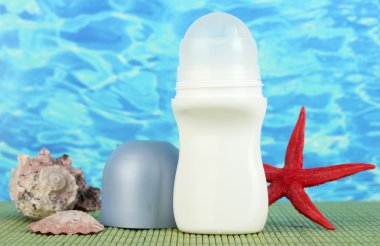 deodorant, fishstar ve kabukları mavi deniz arka plan üzerinde