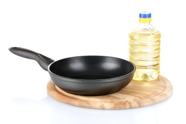 Pan with bottle of oil isolated on white clipart