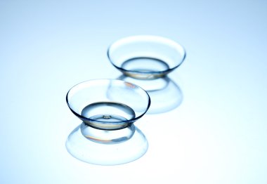 Contact lenses, on blue background clipart