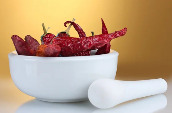 stock image White mortar and pestle with red peppers